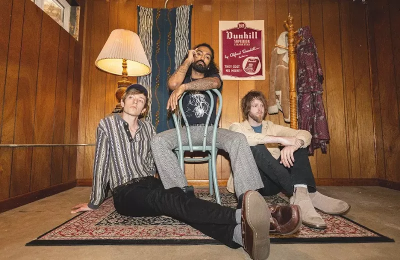 Image: three people sitting in a living room