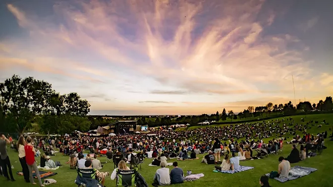 people picnicking at an outdoor venue in the summer