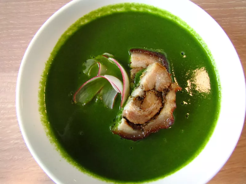 Image: Potato nettle soup with a slice of roasted porchetta.