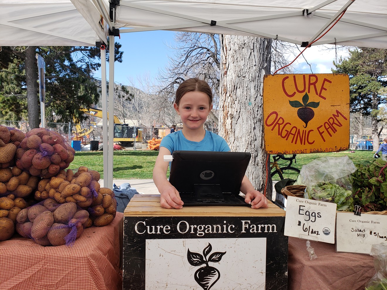 Six-year-old Lauren works her family's stall at the Boulder Farmers' Market.