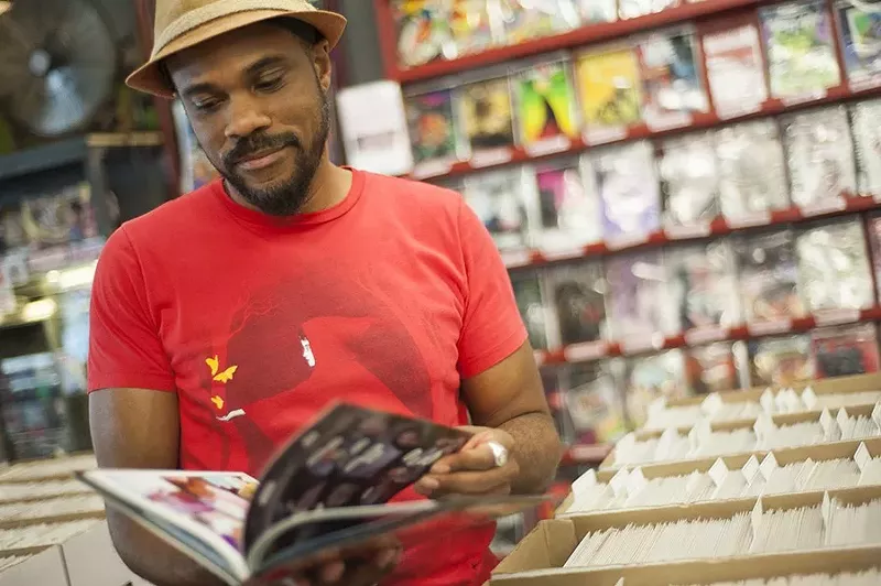 Image: A man flips through a book