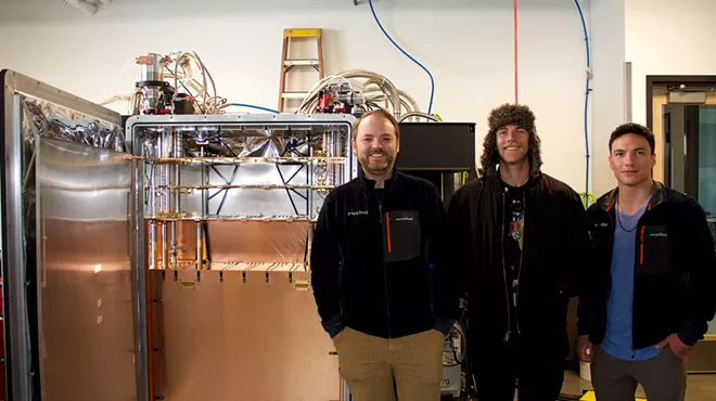 Men stand in front of quantum fridge