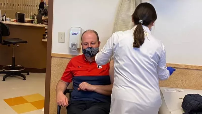 Image: Colorado Governor Jared Polis getting vaccinated in late January.