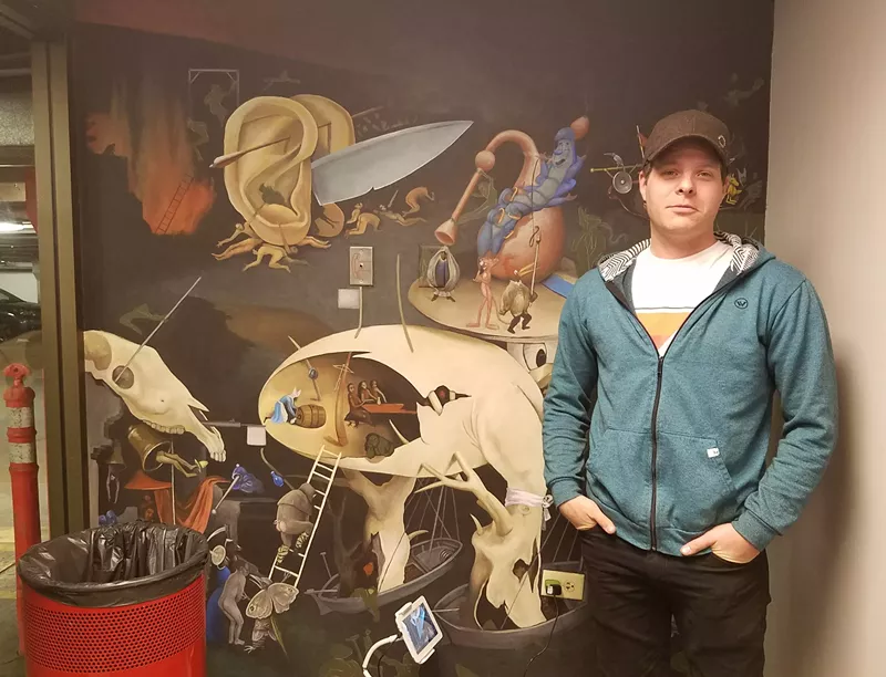 Image: Forrest J. Morrison in front of one of his in-progress murals.
