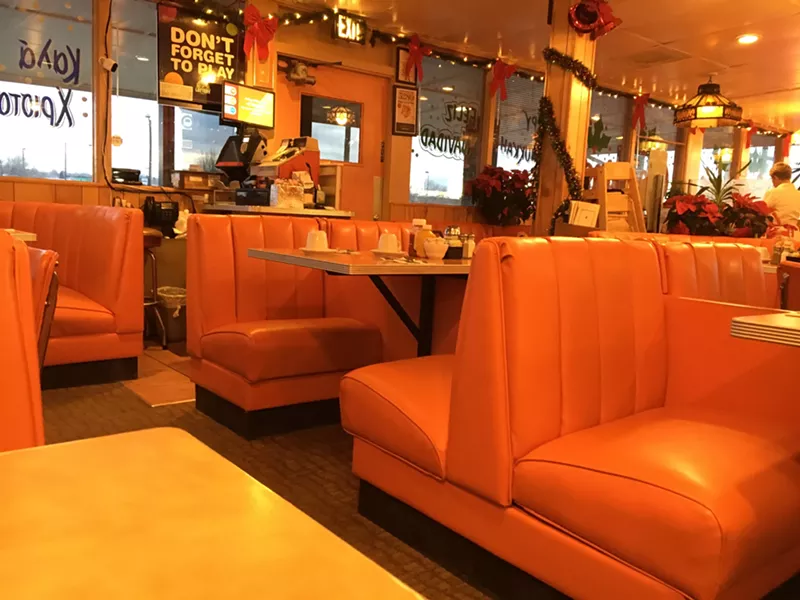 Image: orange booths inside a restaurant
