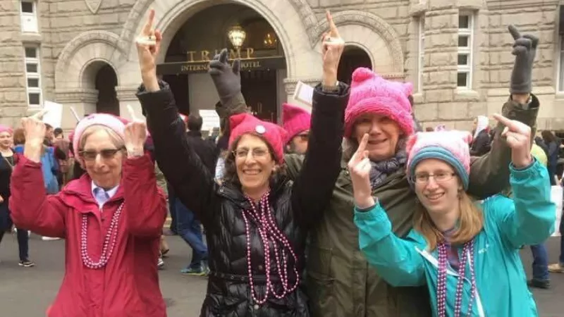 Image: A photo of protesters outside the Trump Hotel in Washington, D.C., shared on the original Indivisible Denver Facebook page in January, before the split.