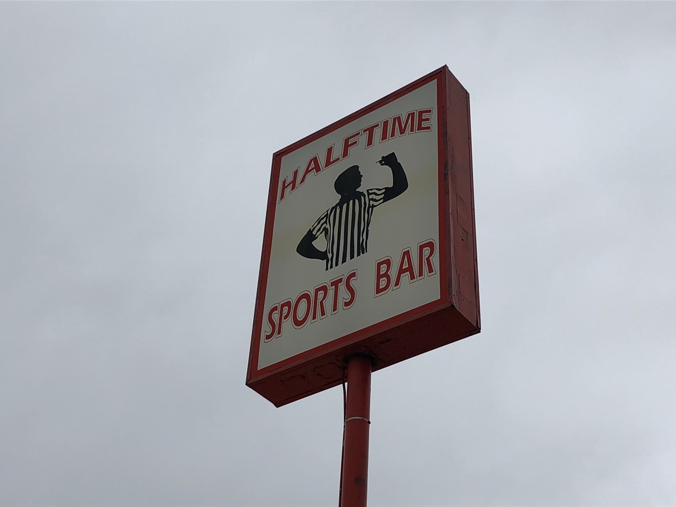 The sign for Halftime Sports Bar is like a beacon on Quebec Street in Commerce City.