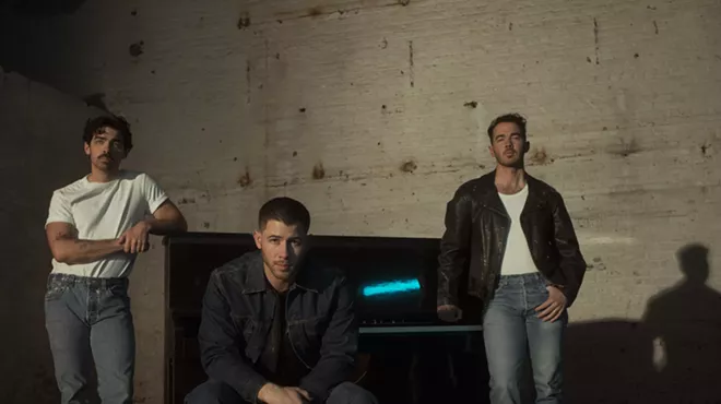 members of the Jonas Brothers looking moody
