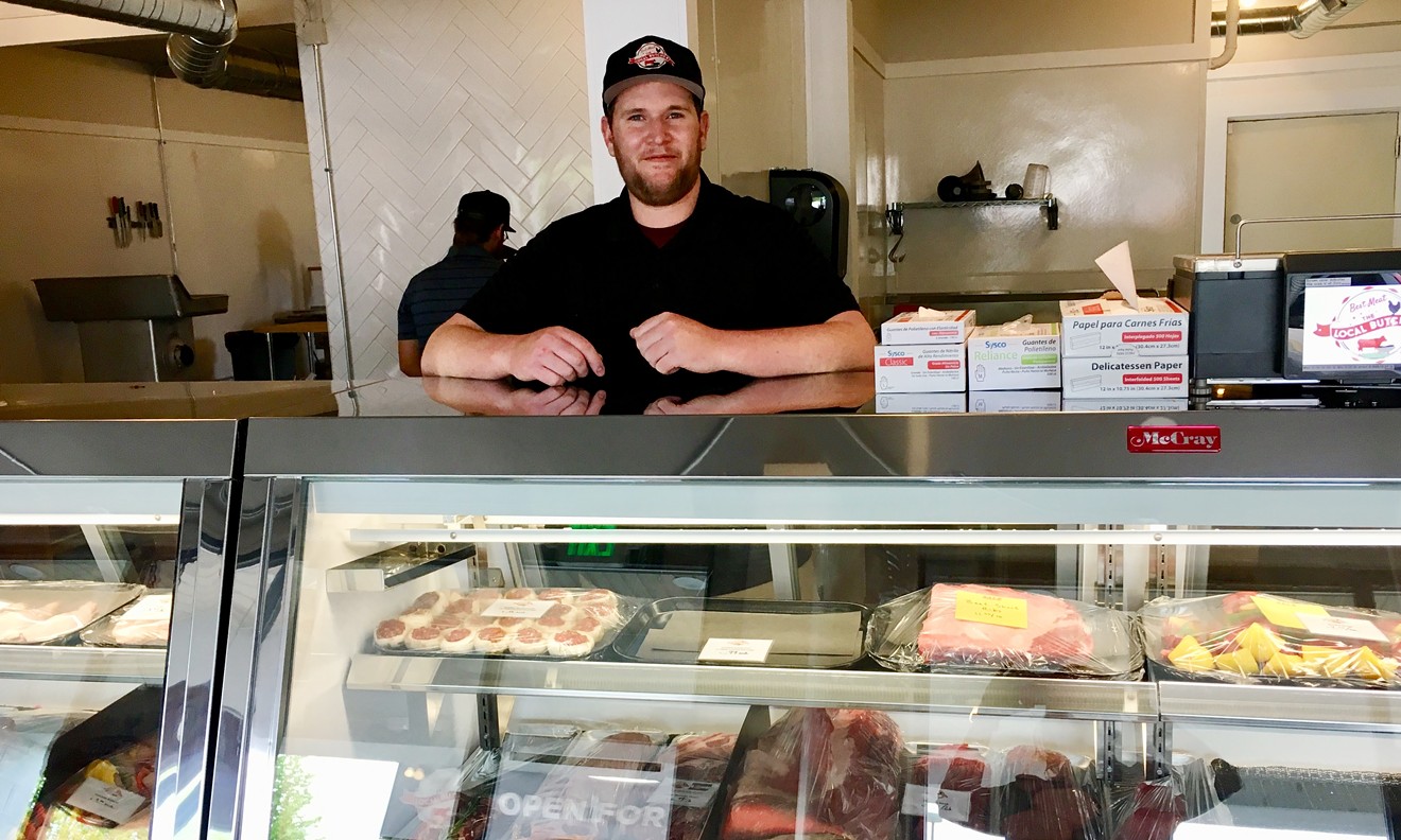 Justin Herd greets new Park Hill customers at the second location of the Local Butcher.