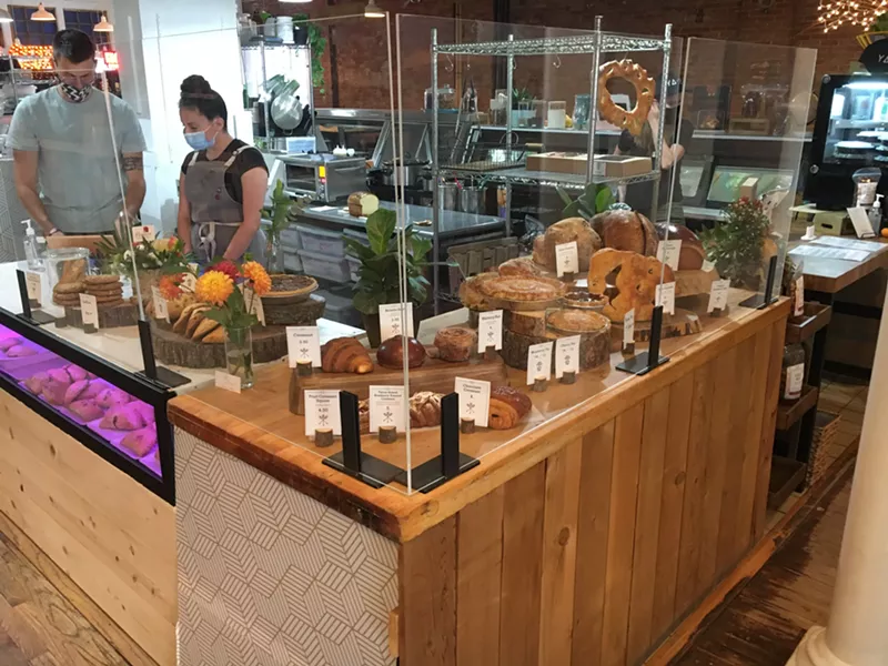 Image: Inside the Farmers Market LSQ, where Rebel Bread and Hinman's Bakery, among several other vendors, are selling their goods.