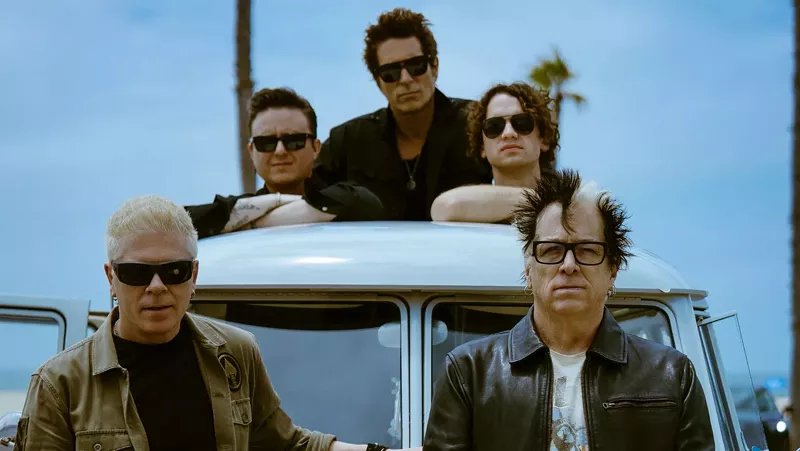 Image: Members of The Offspring pose on a car