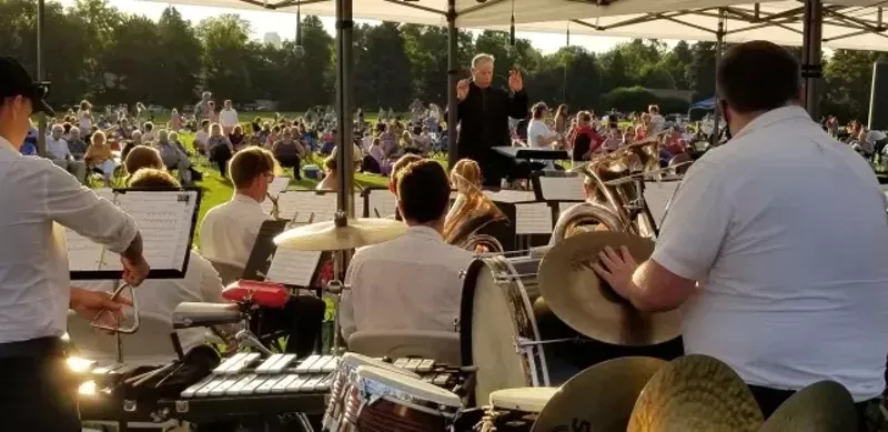 Image: people watching the Denver Municipal Band outdoors