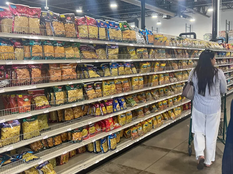 Image: grocery aisle stocked with bags of snacks