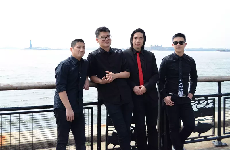 Image: The Slants, an all-Asian American band of musicians fighting in court to trademark their group's name, stand in front of the Statue of Liberty.