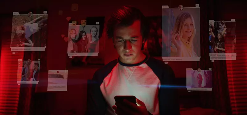 Image: A still from The Social Dilemma, depicting a teenage boy's addiction to screen time.