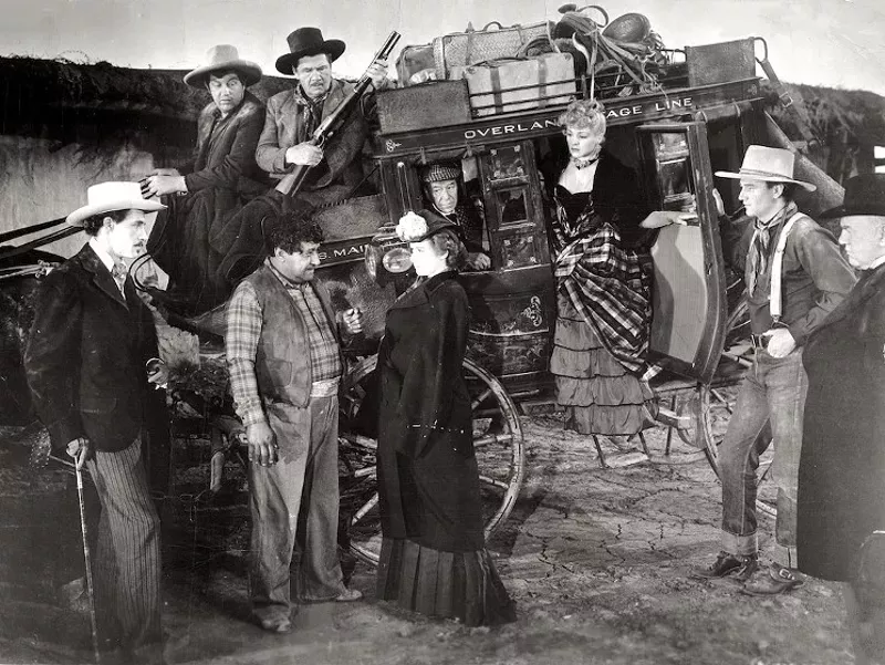 Image: actors by a stagecoach