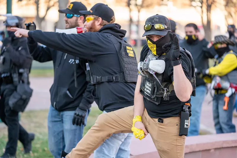 Image: A Denver demonstrator signaling "OK," a symbol commandeered by the Proud Boys to symbolize white supremacy.