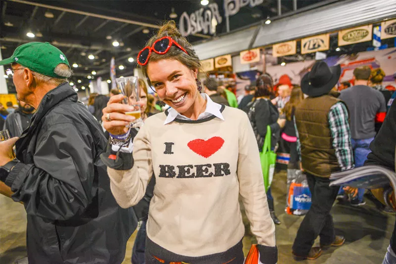 Image: woman holding glass at a beer fest