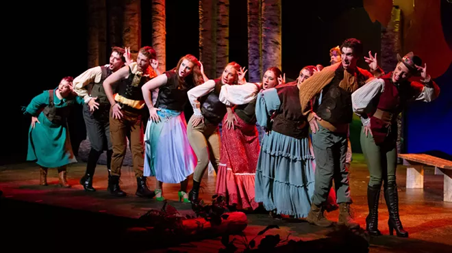 Actors perform a musical number onstage.