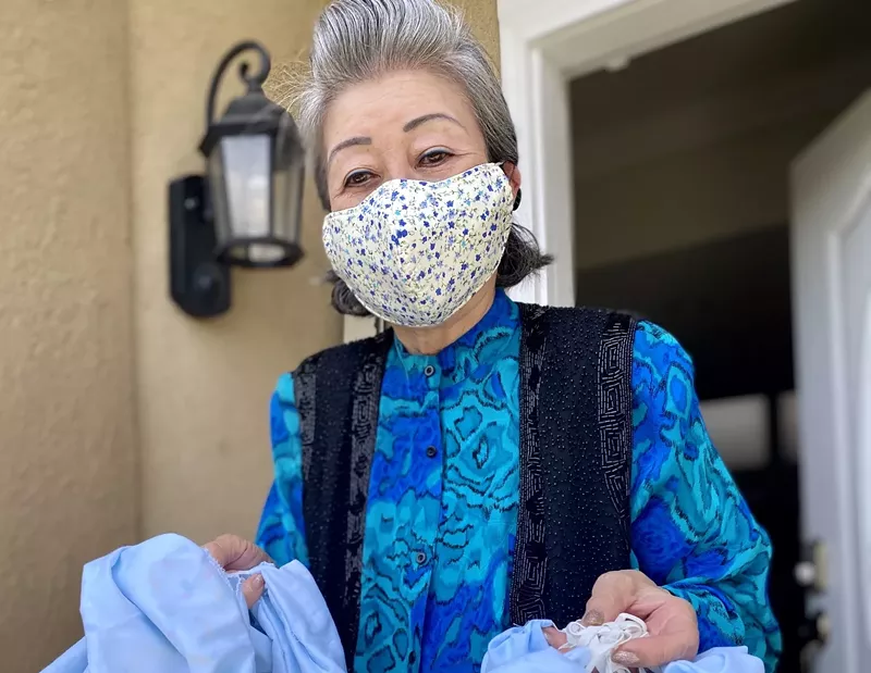 Image: Jessica Kim with some of the 3,500 masks that she and her daughter have made.
