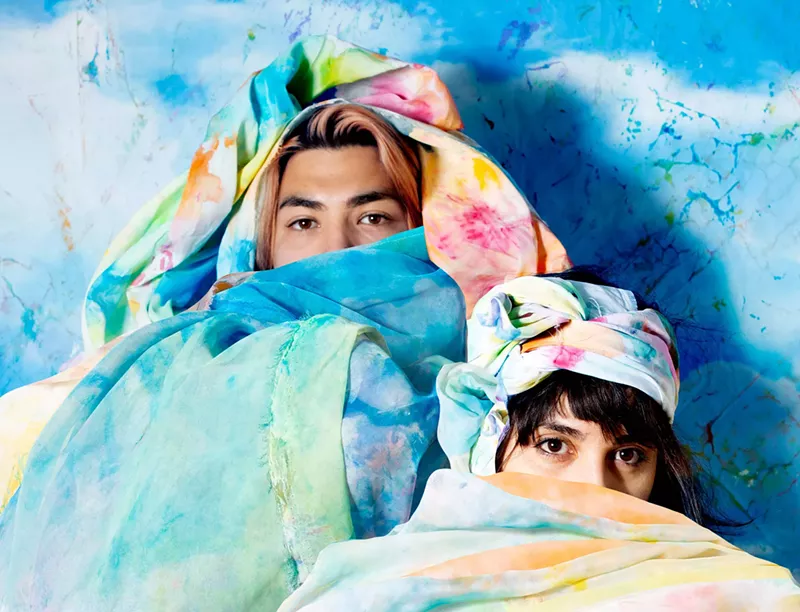 Image: Román Anaya and Alejandra Abad draped in flags.