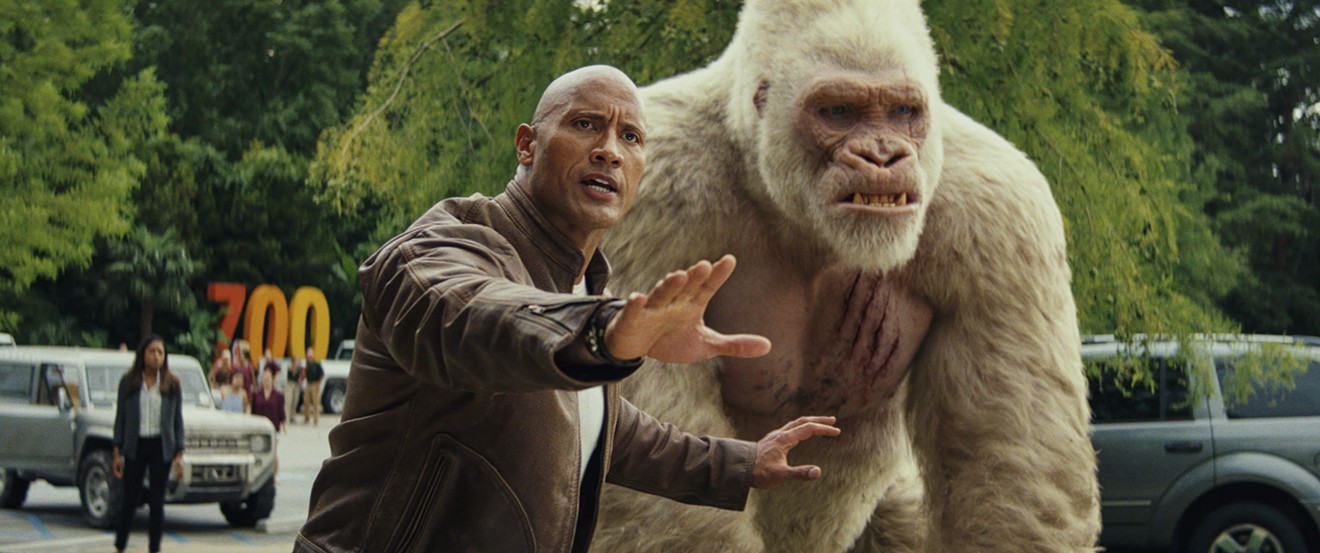 Dwayne Johnson plays Davis, a misanthropic Special Forces soldier-turned-primatologist who trades solemn fist-bumps and sign-language dirty jokes with George, an ape that turns into a giant monster, in Rampage.