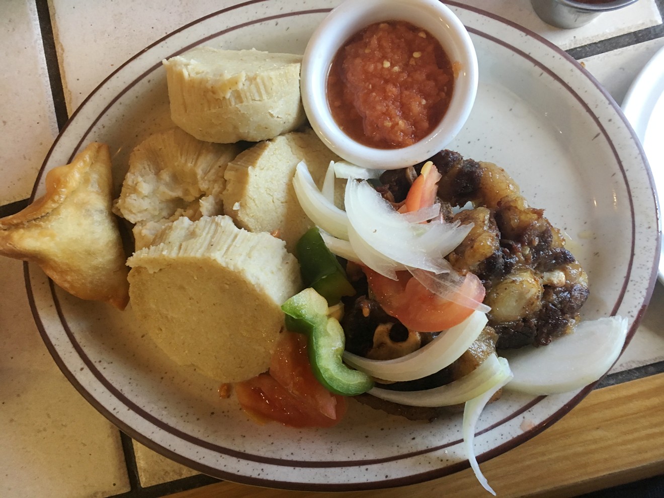 Kenkey is lightly fermented and steamed cornmeal from West Africa, here served with braised oxtail.