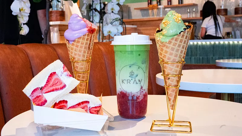Image: two waffle cones, a strawberry and cream sandwich and a boba drink