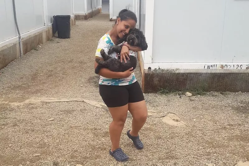 Image: Venezuelan migrant Rosemely Perez embraces her dog.