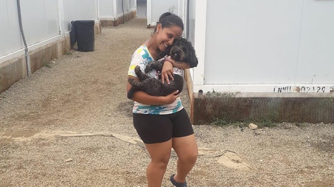 Venezuelan migrant Rosemely Perez embraces her dog.