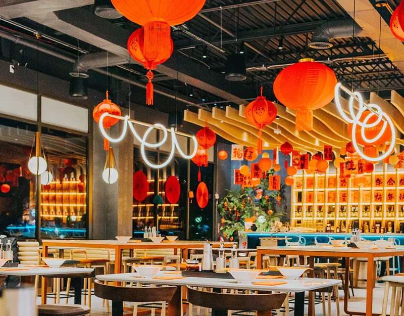 Image: red lanterns hanging over a restaurant dining room