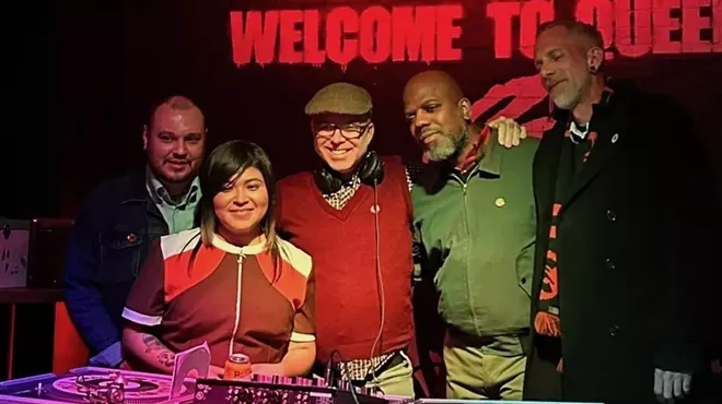 The five DJs of Denver Vintage Reggae Society standing behind turntables