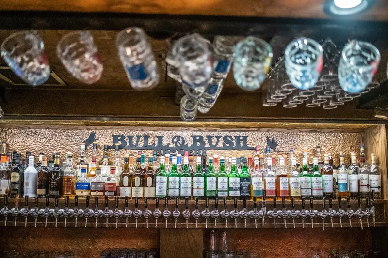 Image: a bar lined with bottles