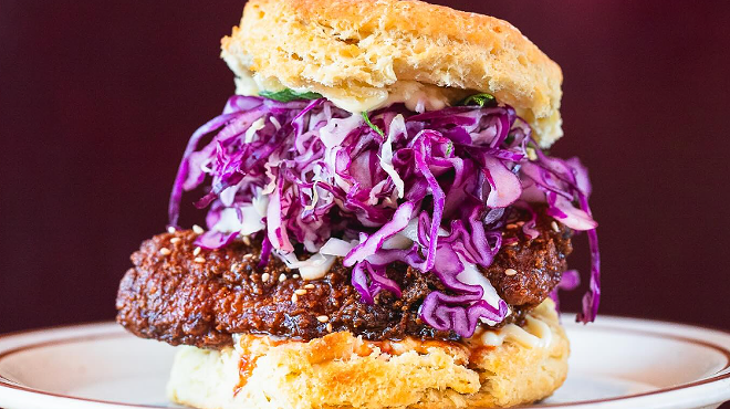 a biscuit sandwich with fried chicken and cabbage