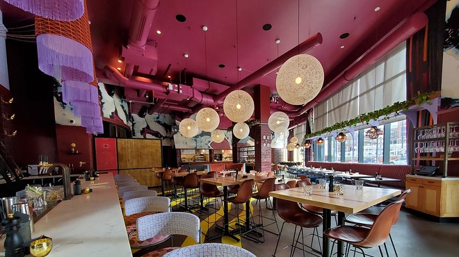 interior of a restaurant with a pink ceiling