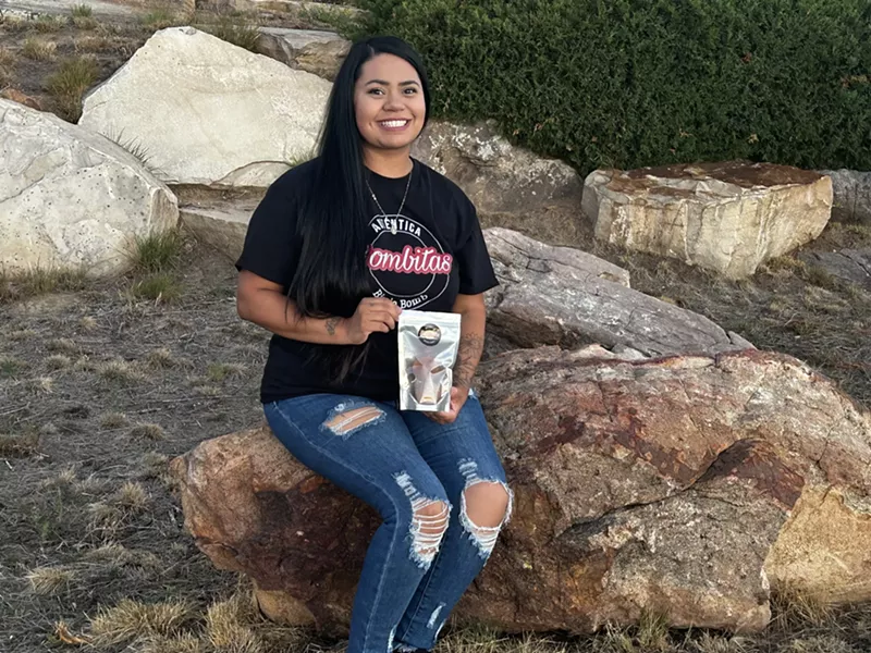 Image: woman posed outdoors with a Bombitas birria bomb package