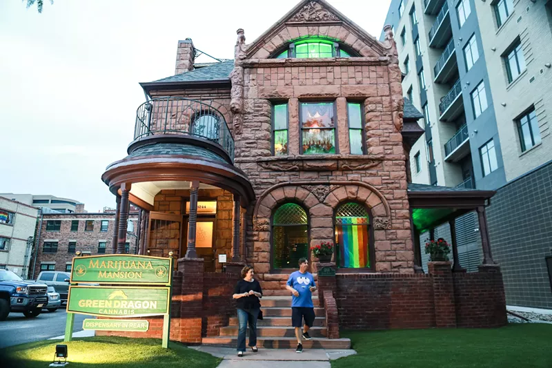 Image: People stand outside of Denver's Marijuana Mansion in Capitol Hill