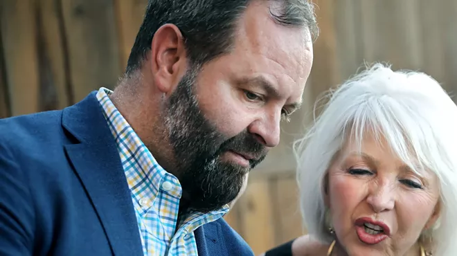 man with beard in jacket with blonde woman
