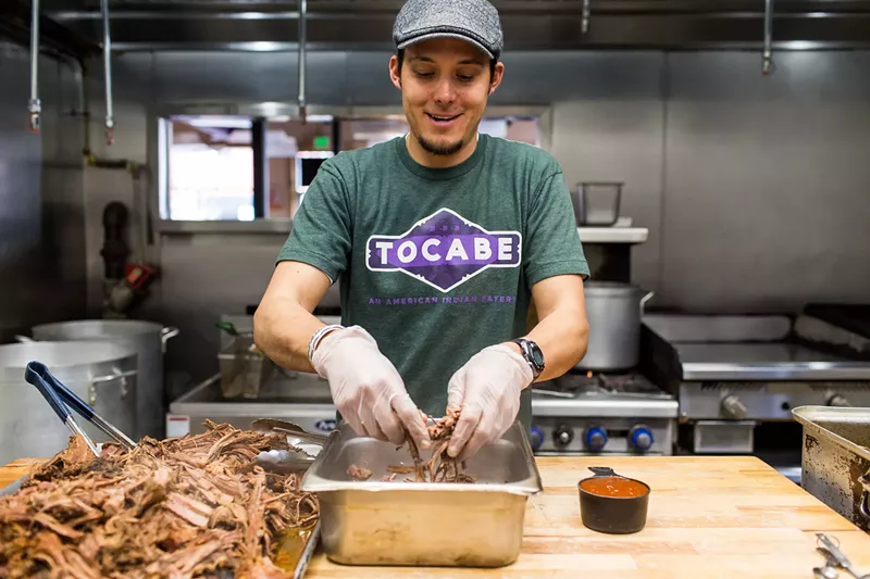Image: Co-founder Ben Jacobs cooking at Tocabe: American Indian Eatery.