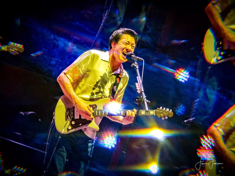 Image: man playing guitar and singing