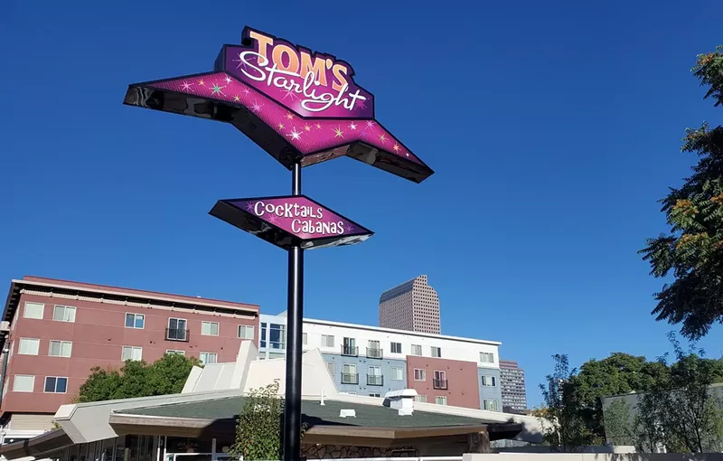 Image: pink diner sign against sky.