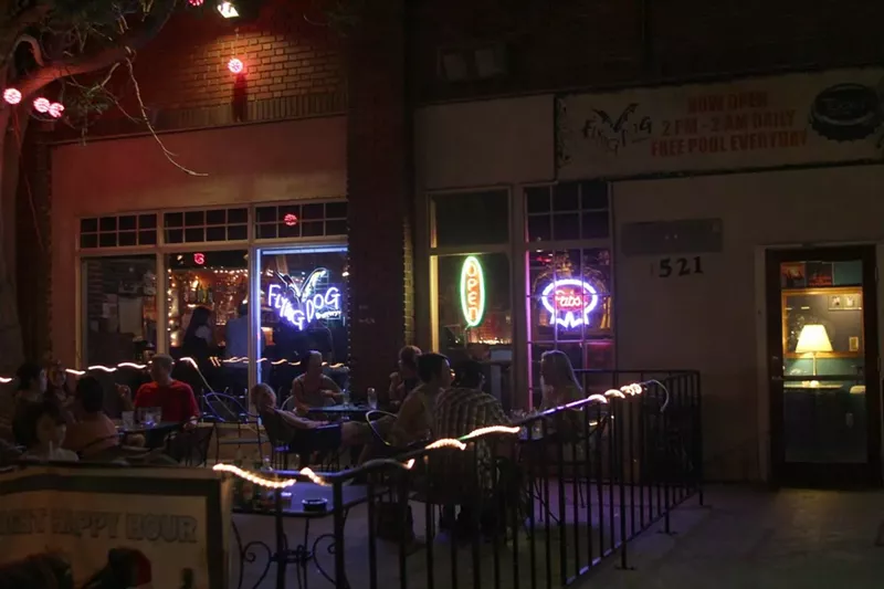 Image: The small concrete patio basks in the glow of neon beer signs at Tooey's Off Colfax.