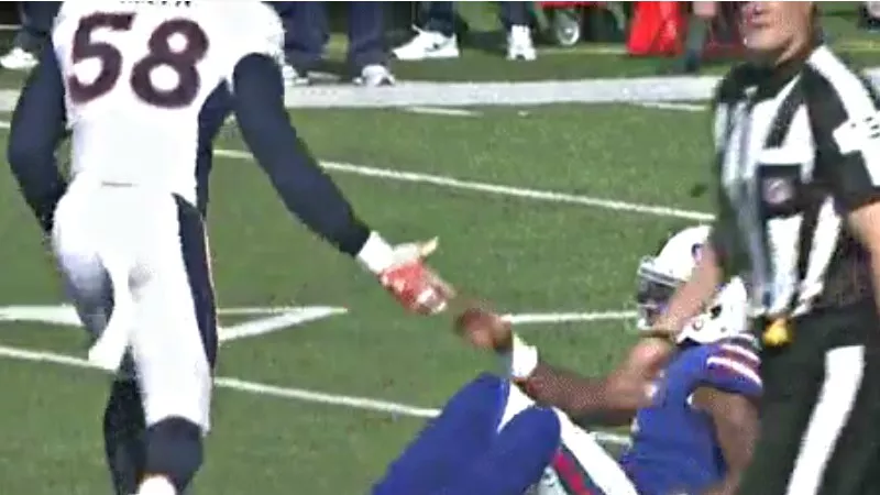 Image: Von Miller pretending to help up Tyrod Taylor — a joke that resulted in a costly penalty for the Denver Broncos.