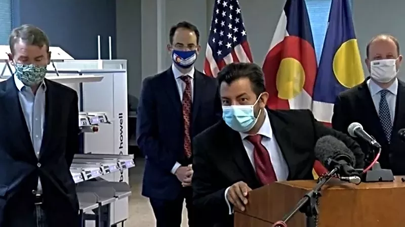 Image: Senator Michael Bennet, Colorado Attorney General Phil Weiser, Denver Clerk and Recorder Paul López and Colorado Governor Jared Polis during an August 17 press conference at the Denver Elections Division.