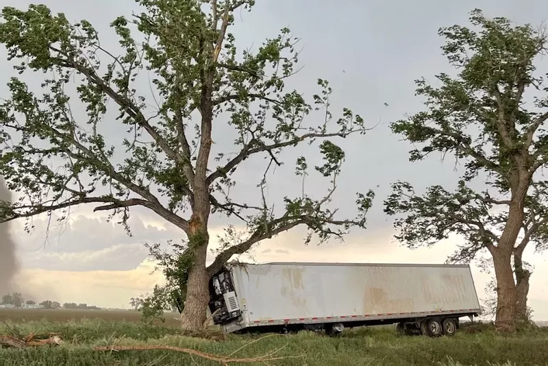 Image: A semi trailer was thrown across a field at Miller Farms when a tornado touched down on June 7.