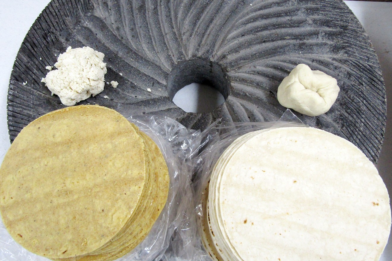 Nixtamal (left) and Maseca (right) masa and tortillas on a stone wheel from the corn grinder at Raquelitas.