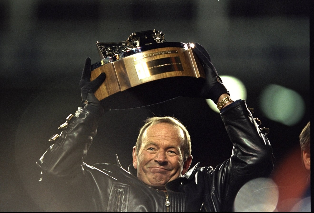 Pat Bowlen holds up the trophy after the Denver Broncos won the AFC Championship Game at Mile High Stadium in 1999.