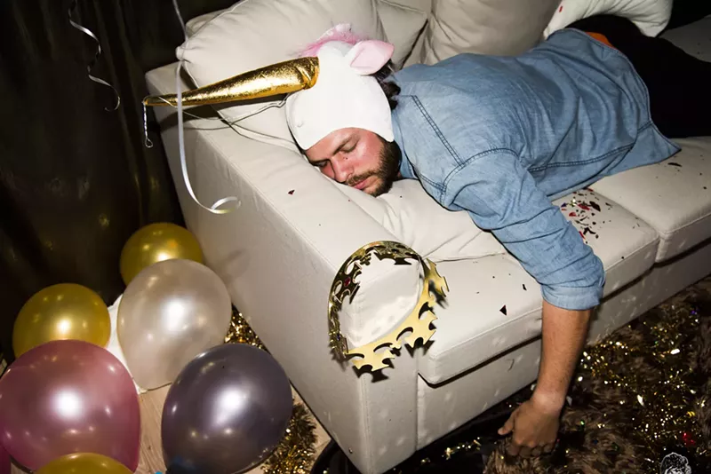 Image: Man passed out on couch after night of partying