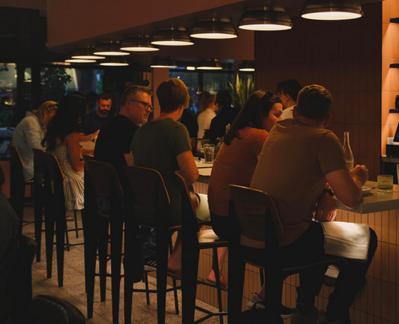 Image: people seated at a counter