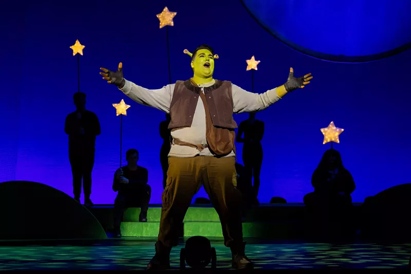 Image: man dressed as a green ogre on stage